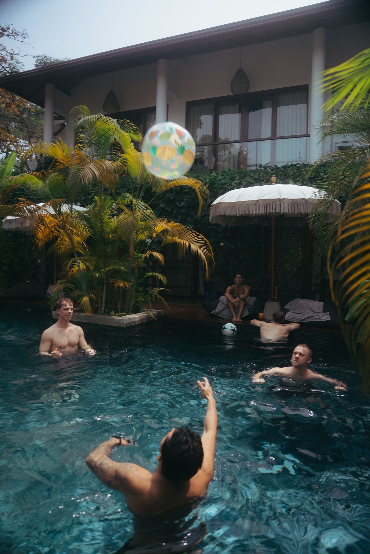 The tribe playing with a beach ball in the pool